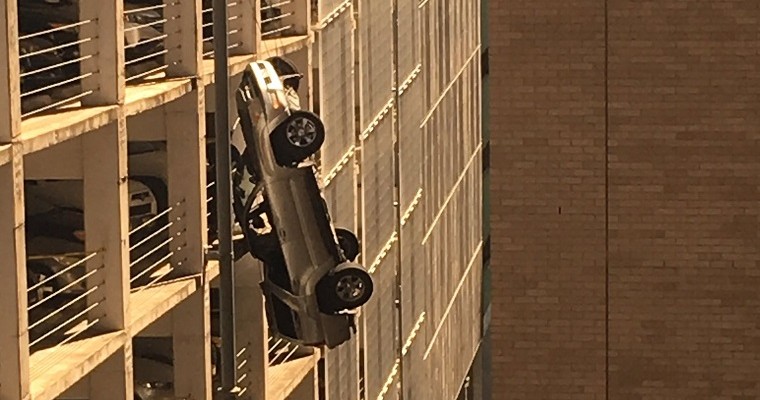 Man Drives Toyota Off the Roof of a Parking Garage, Lives to Tell the Tale