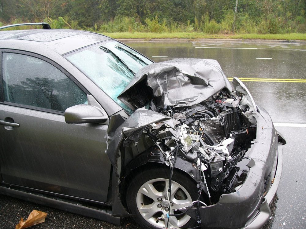 small car with crumpled front end due to a collision