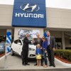 Timothy Bush and his family accepting the keys to the very first Hyundai Tucson Fuel Cell vehicle