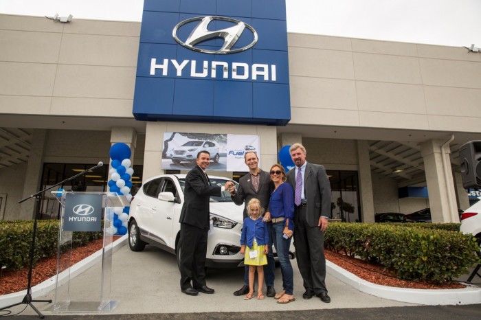 Timothy Bush and his family accepting the keys to the very first Hyundai Tucson Fuel Cell vehicle