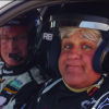 Race car driver Kelly Collins (left) and comedian Jay Leno (right), who's helmet can barely contain his face test driving a Porsche 911