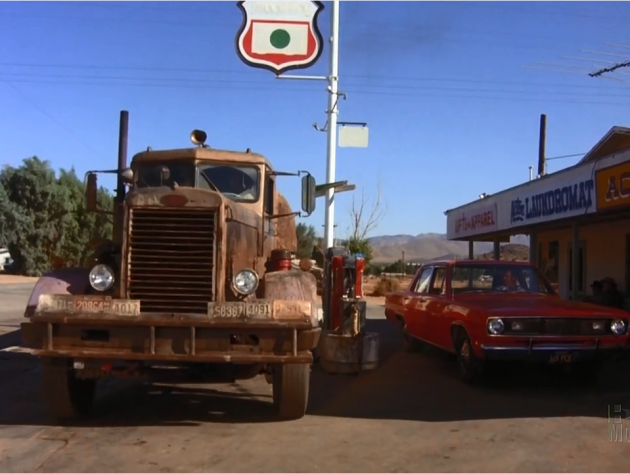 Mann's Plymouth Valiant, overshadowed by the massive truck