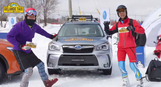 Skiers in Shinshu Sugadaira  pose next to a Subaru Slope Taxi