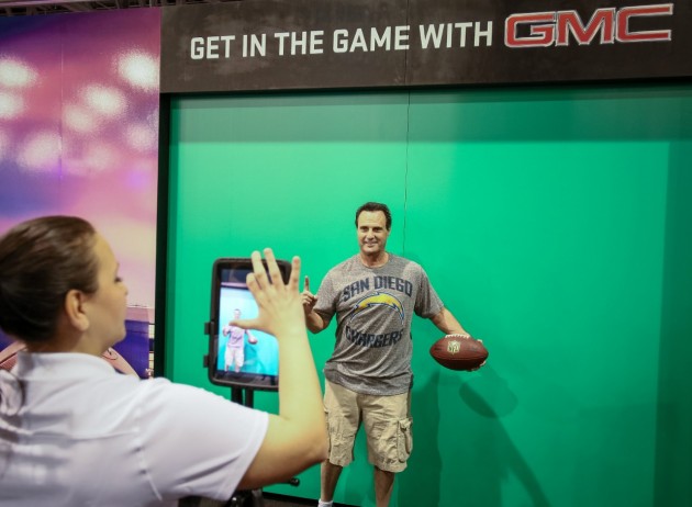 A fan poses for a mock Madden NFL 2015 video game cover