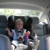 child in front-facing car seat secured in the rear middle seat