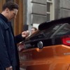 Benedict Cumberbatch as Sherlock Holmes persona in Chinese MG Cars ad inspecting orange MG GS