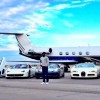 Mayweather poses in front of his personal jet and eight exotic vehicles.