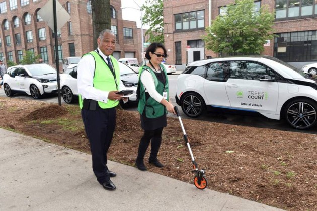 With 20 donated BMW i3 electric vehicles, NYC Parks Commissioner Mitchell J. Silver and NYC Chief Technology Officer Minerva Tantoco map the first trees of the TreesCount! 2015 census during a press conference at Julio Carballo Fields on Tuesday, May 19, 2015 in the Bronx Borough of New York. (Photo by Scott Gries/Invision for BMW of North America/AP Images)