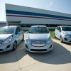 Three Chevy Spark EVs parked outside the Baltimore Complex