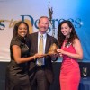 Morgan Grayned (left) and Zineb Bouzoubaa (right) present Greg Martin, executive director of GM Global Public Policy, with the Social Responsibility Award from Scholarship America