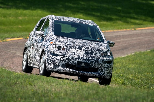 A camouflaged Chevy Bolt EV undergoes testing at GM's proving grounds in Milford, Michigan