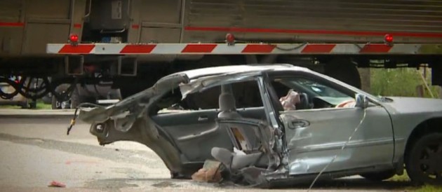 Car ripped in half by train