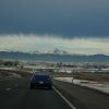 The E-470 toll road in the Denver, Colorado metro area with mountains in the background