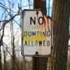 man defecates in police car - no dumping allowed sign