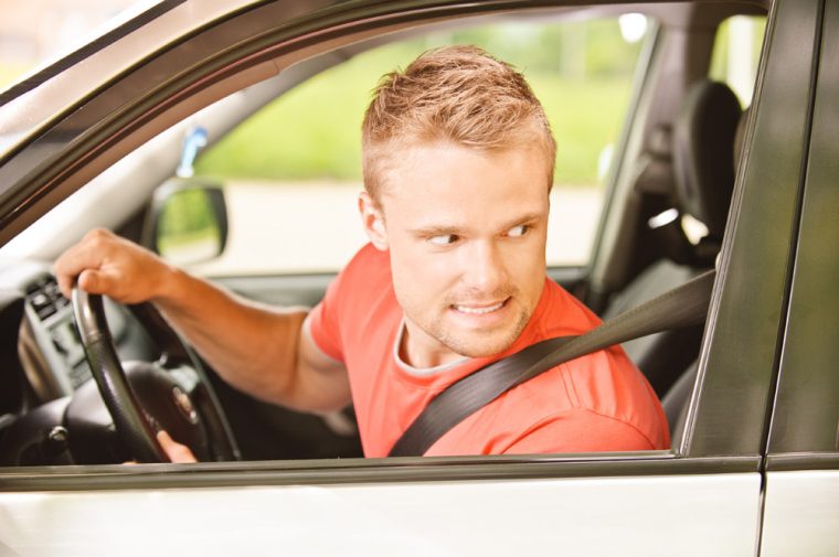 man sitting in car driver waiting seatbelt