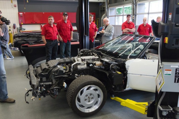 GM technicians work to restore the badly damaged 1992 C4 Corvette convertible