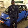 Rapper 50 Cent poses in front of Smart car.