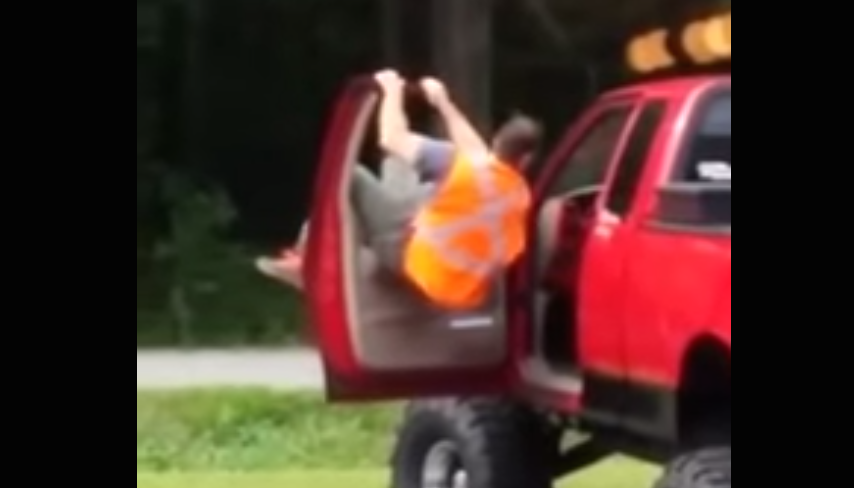 drunk guy tries to climb from bed of truck to cab video