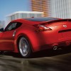 2016-370z-coupe-touring-sport-solid-red-back-view-highway-driving-large
