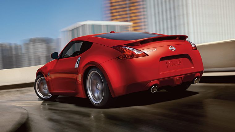 2016-370z-coupe-touring-sport-solid-red-back-view-highway-driving-large