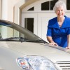 Senior Citizen standing by car old person woman