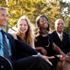 Laughing business people on a bench