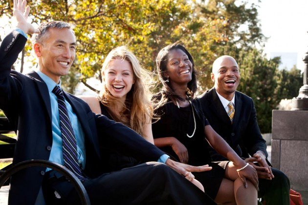 Laughing business people on a bench