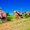 Painted Volkswagen Beetles sticking out of the ground at VW Slug Bug Ranch in Conway, Texas