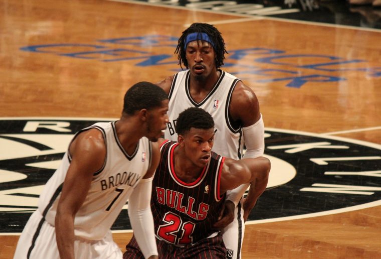 Bulls player Jimmy Butler (center) refuses to look back at Gerald Wallace