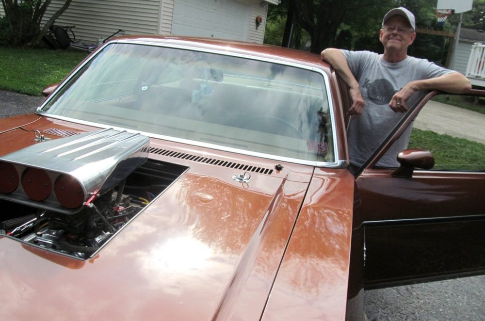 Elderly man with classic Chevrolet Nova