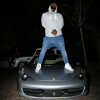 The Game stands on top of his Ferrari 458, Is his Ferrari better than Bieber's and Jennenr's?