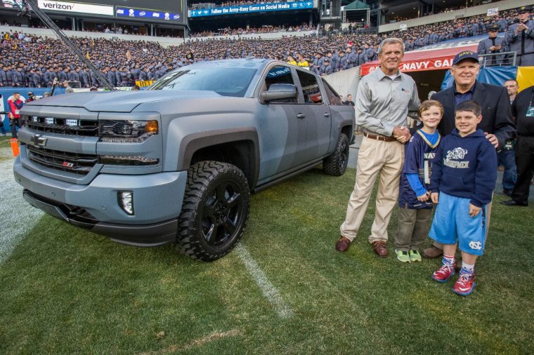 Former General Motors Chairman and CEO Dan Akerson (right), a U.S. Naval Academy graduate, presents retired U.S. Navy SEAL Master Chief and Executive Director National Navy SEAL Museum Rick Kaiser with a Chevy Silverado Special Ops Concept vehicle Saturday, December 12, 2015 at the Army-Navy football game in Philadelphia, Pennsylvania. 