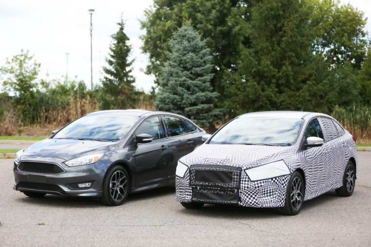 Ford Fusion near a camouflaged model