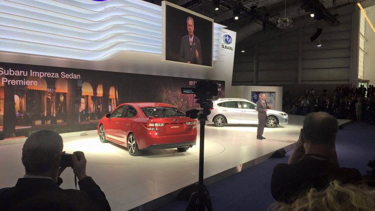 The 2017 Subaru Impreza Sedan (red) and 5-Door (white) on display at the New York International Auto Show during their debut