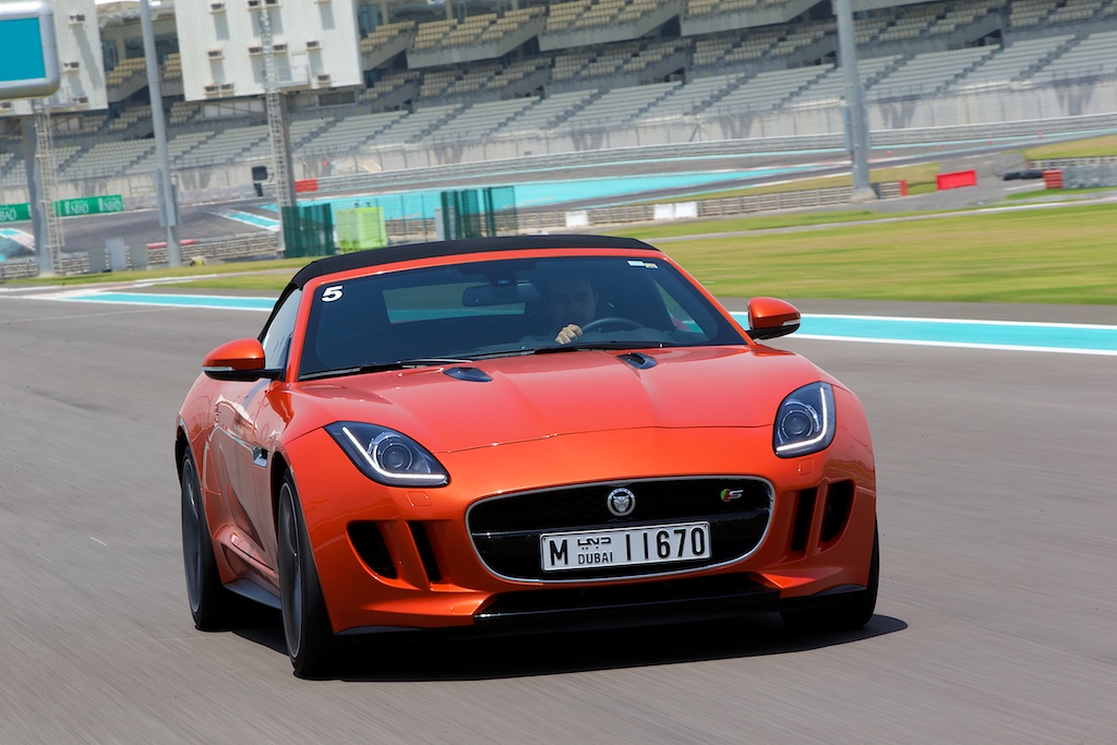 Orange Jaguar F-TYPE on a track at an exotic supercar driving experience