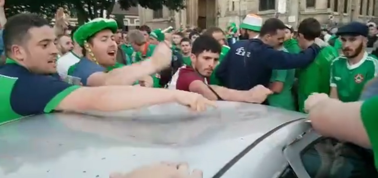 Irish soccer fans fix a car