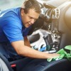 man washing cleaning car interior wiping leather seats