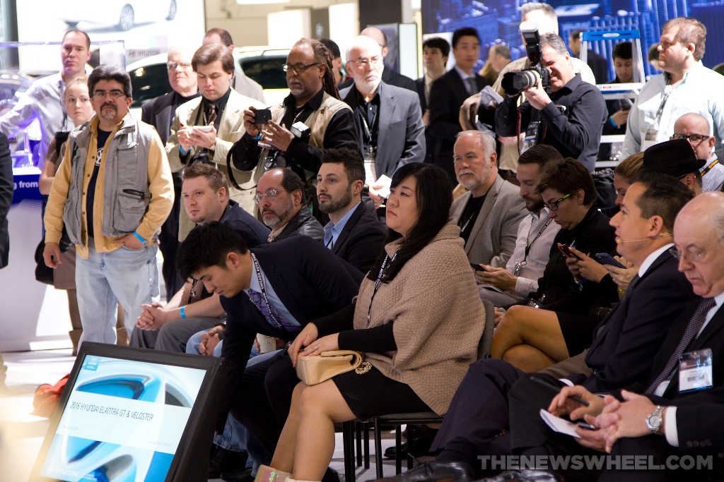 media journalists at press conference at auto show