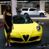 model next to Alfa Romeo 4C Spider