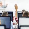 teacher asking questions student raising hand to answer at computer