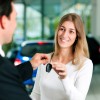 woman car shopping buying leasing at car dealership keys