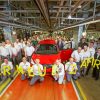 Workers pose with the new Opel Zafira at plant