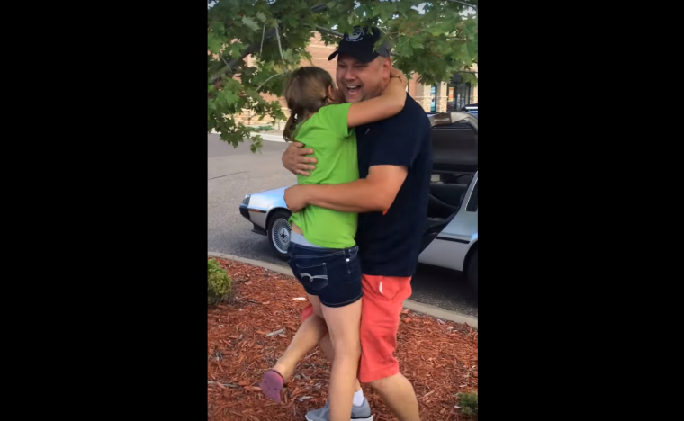 Girl hugs her dad for buying a DeLorean in "First time seeing a DeLorean" video on YouTube