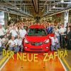 Workers pose with the new Opel Zafira at plant