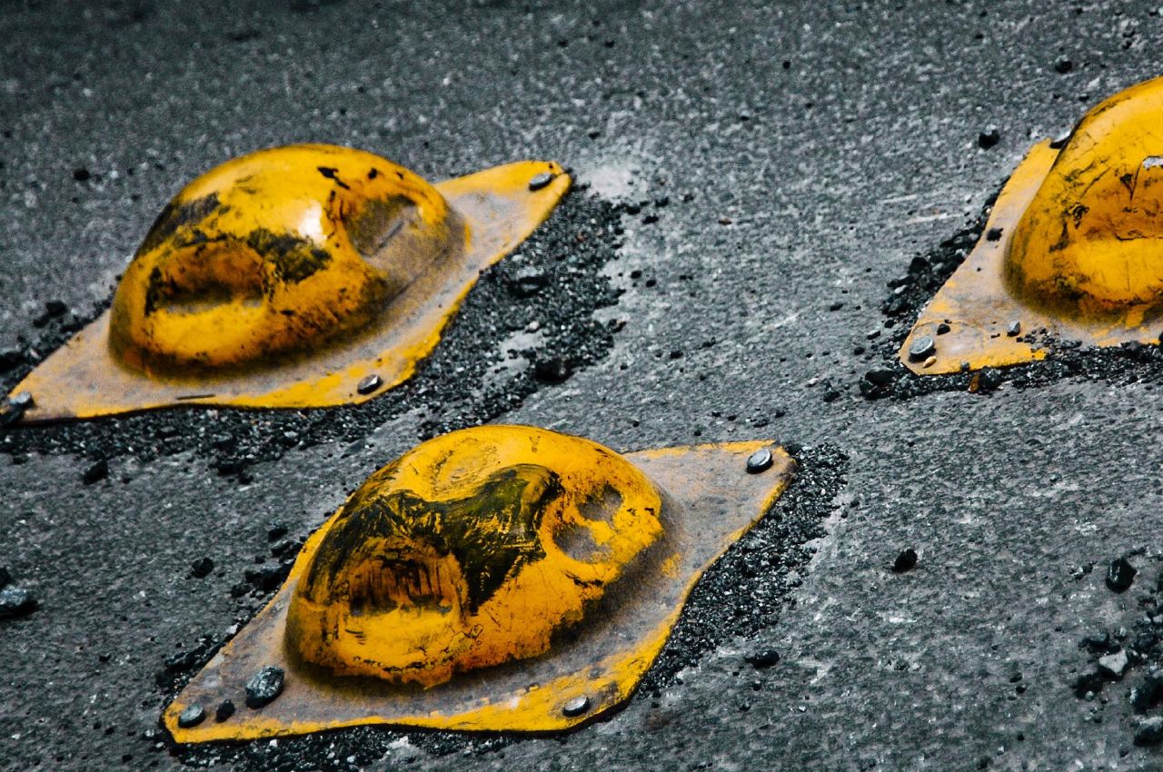 yellow speed bumps designed to slow car traffic