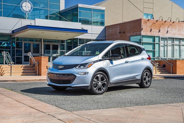 The 2017 Chevy Bolt EV parked in front of a building