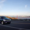 The 2017 Buick Enclave driving along a road with Golden Gate Bridge in background