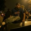 Cubs fans celebrate by wrecking cars near Wrigley Field after Chicago wins World Series