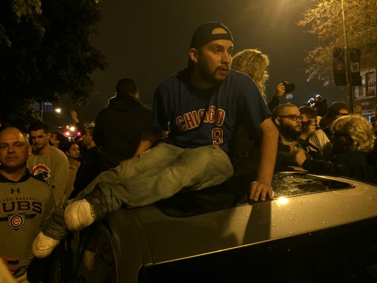 Cubs fans celebrate by wrecking cars near Wrigley Field after Chicago wins World Series