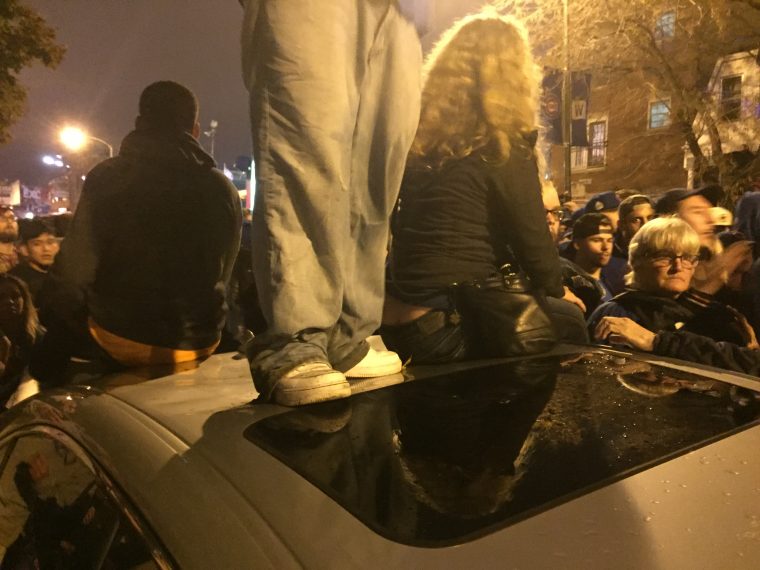 Cubs fans celebrate by wrecking cars near Wrigley Field after Chicago wins World Series